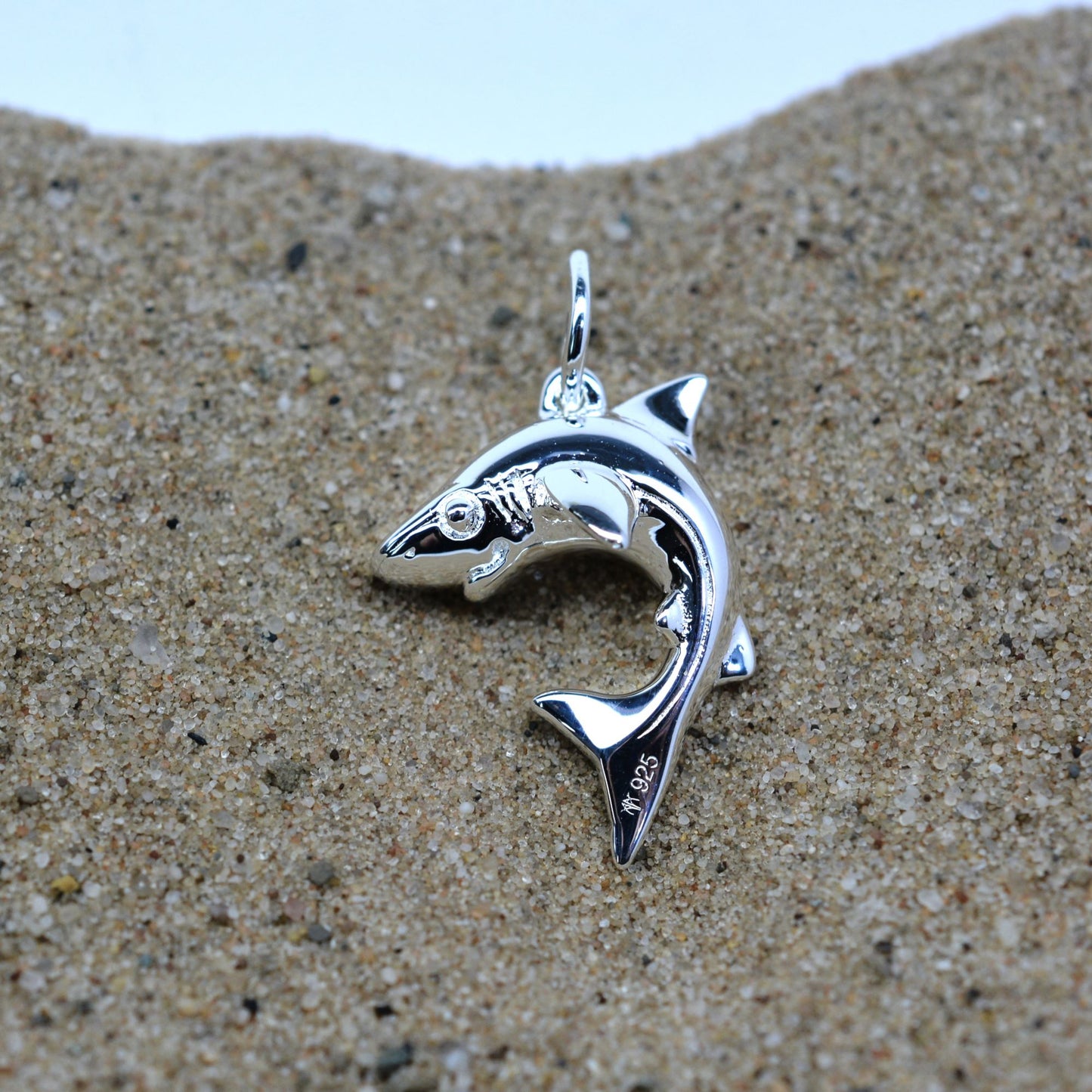 Baby shark charm 3D necklace made from highly polished, tarnish resistant silver, strung on a strong cord. © Adrian Ashley