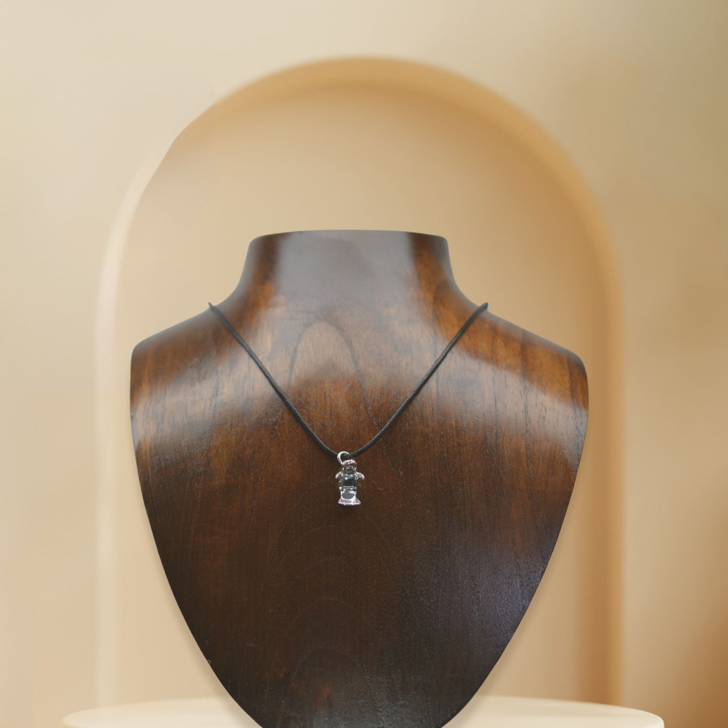 Manatee charm necklace. Made from highly polished, tarnish resistant silver, strung on a strong cord. © Adrian Ashley