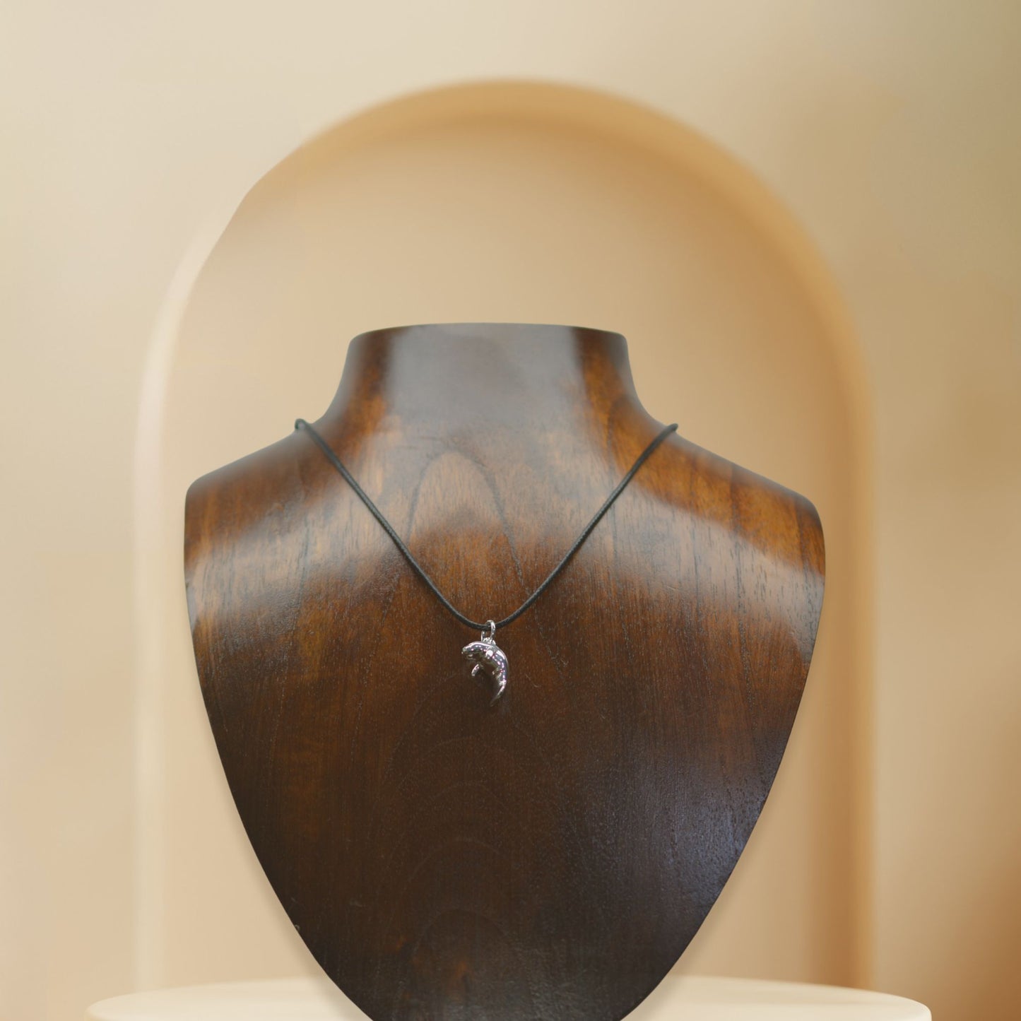 Manatee charm necklace. Made from highly polished, tarnish resistant silver, strung on a strong cord. © Adrian Ashley