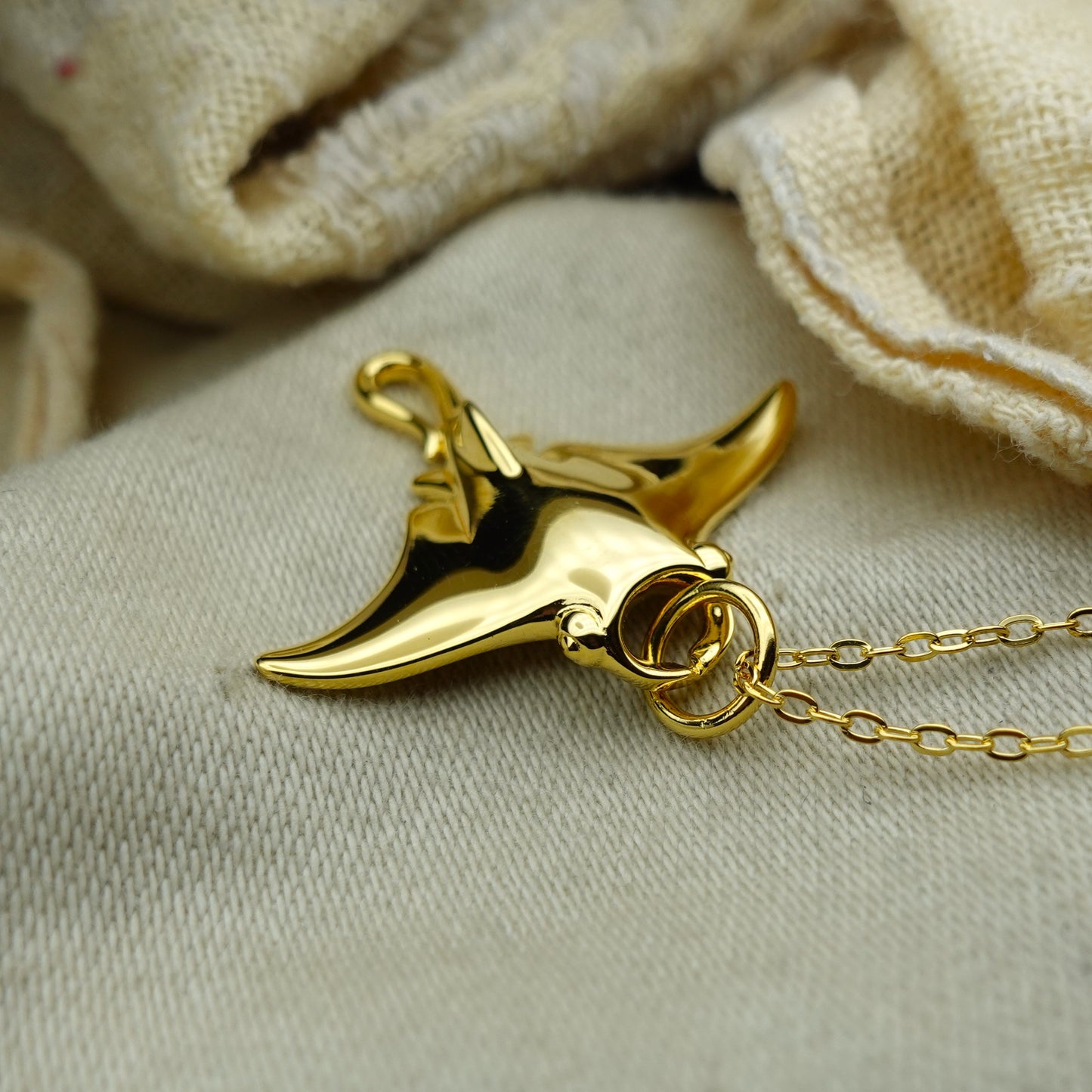 Gold plated silver Manta Ray pendant and chain. © Adrian Ashley