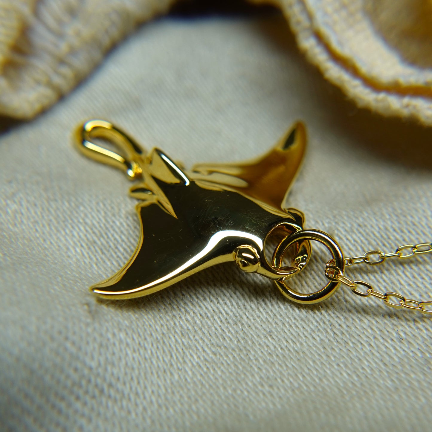 Gold plated silver Manta Ray pendant and chain. © Adrian Ashley