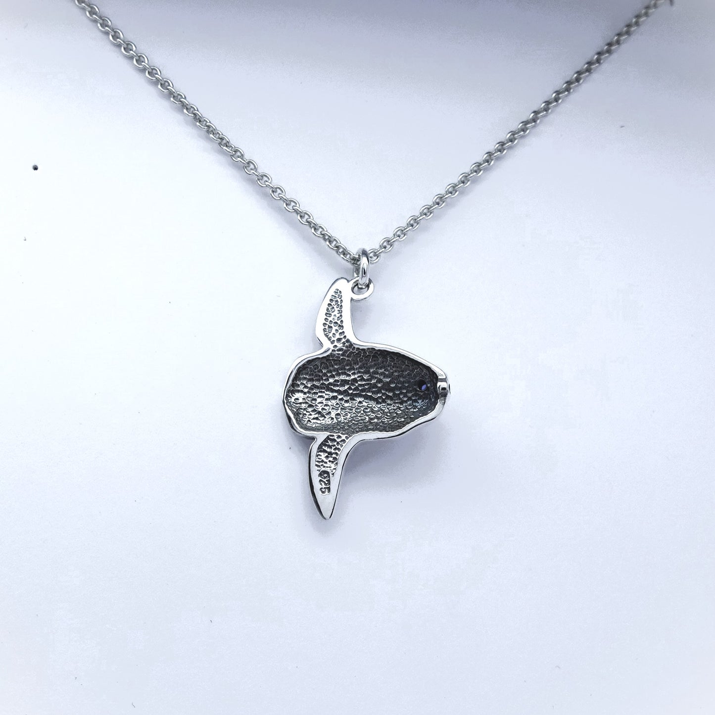 Mola mola necklace. Made from sterling silver with an antiqued finish, set with a gemstone eye. Ocean sunfish or moonfish © Adrian Ashley
