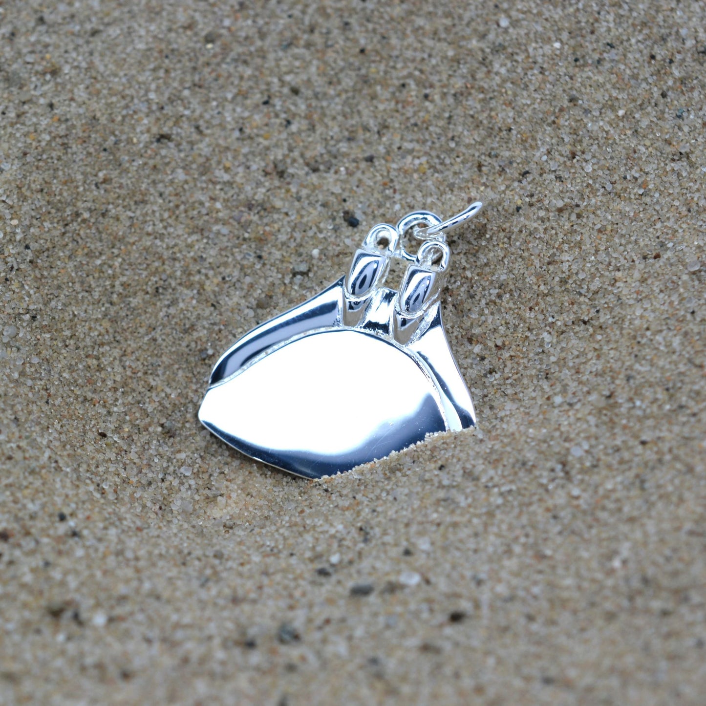 Freediving monofin or monoplame necklace. Made from highly polished, tarnish resistant silver, hung on a silver chain. © Adrian Ashley