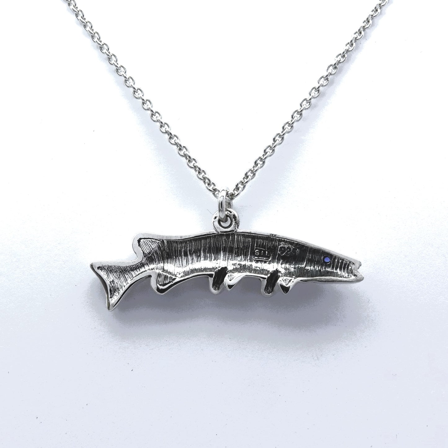 Pike fishing necklace. Made from sterling silver with an antiqued finish, set with a gemstone eye.. Ideal fisherman’s angling gift © Adrian Ashley