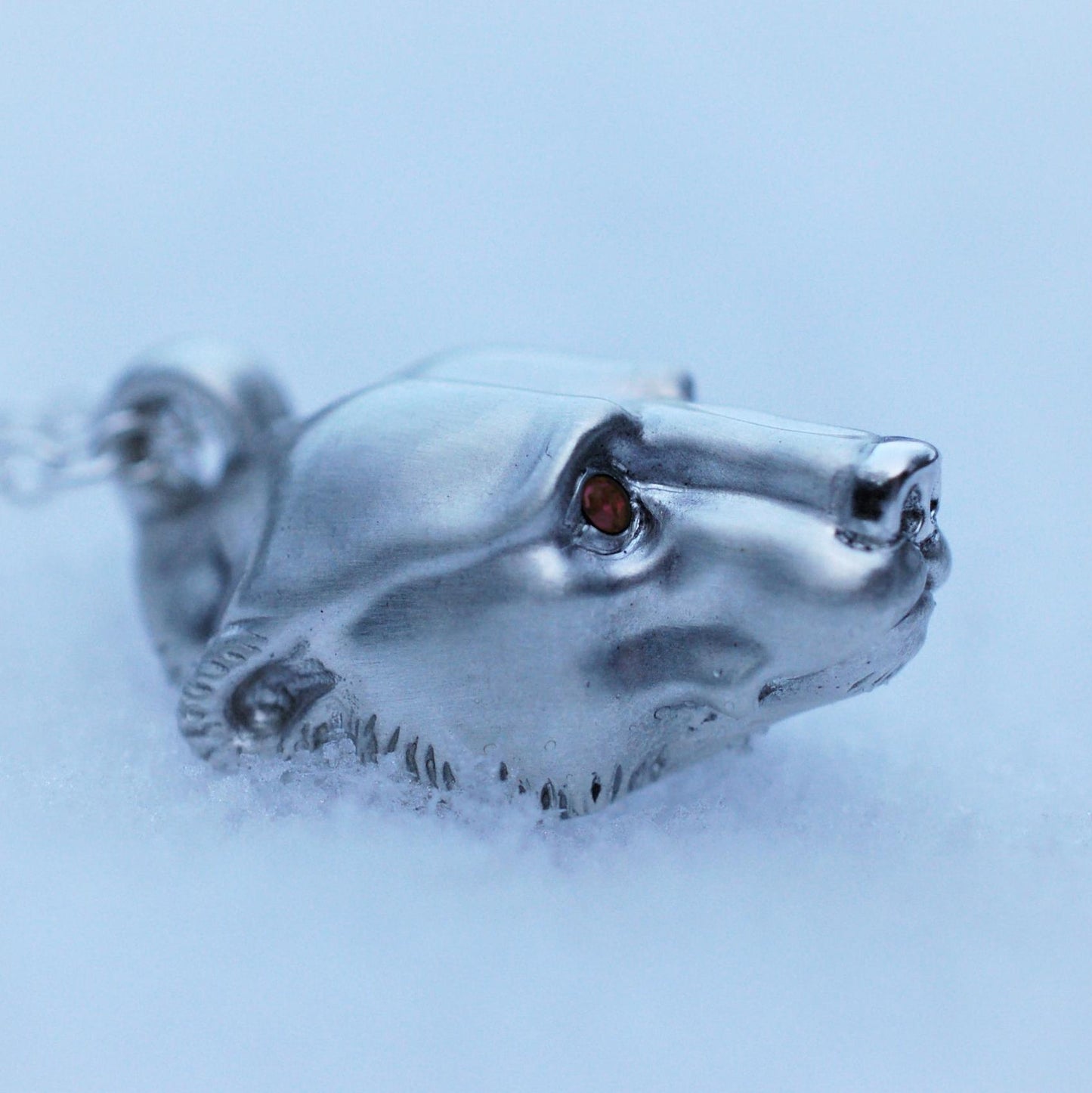 Silver polar bear pendant and chain. Satin finished with a shiny nose and Greenland ruby eyes. © Adrian Ashley