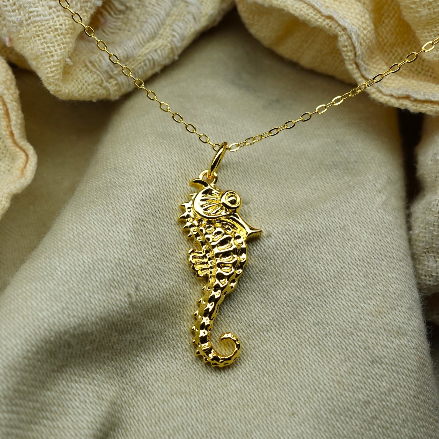 Gold plated silver Seahorse pendant and chain. © Adrian Ashley