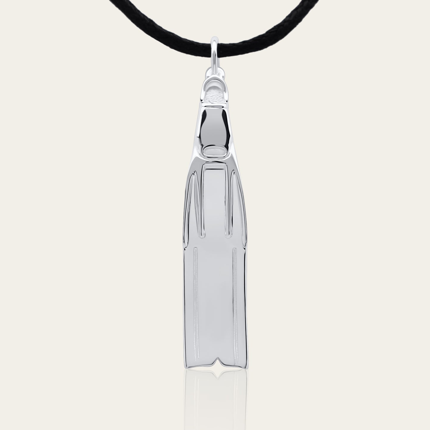 Freediving fin necklace. Made from highly polished, tarnish resistant silver, strung on a strong cord. © Adrian Ashley