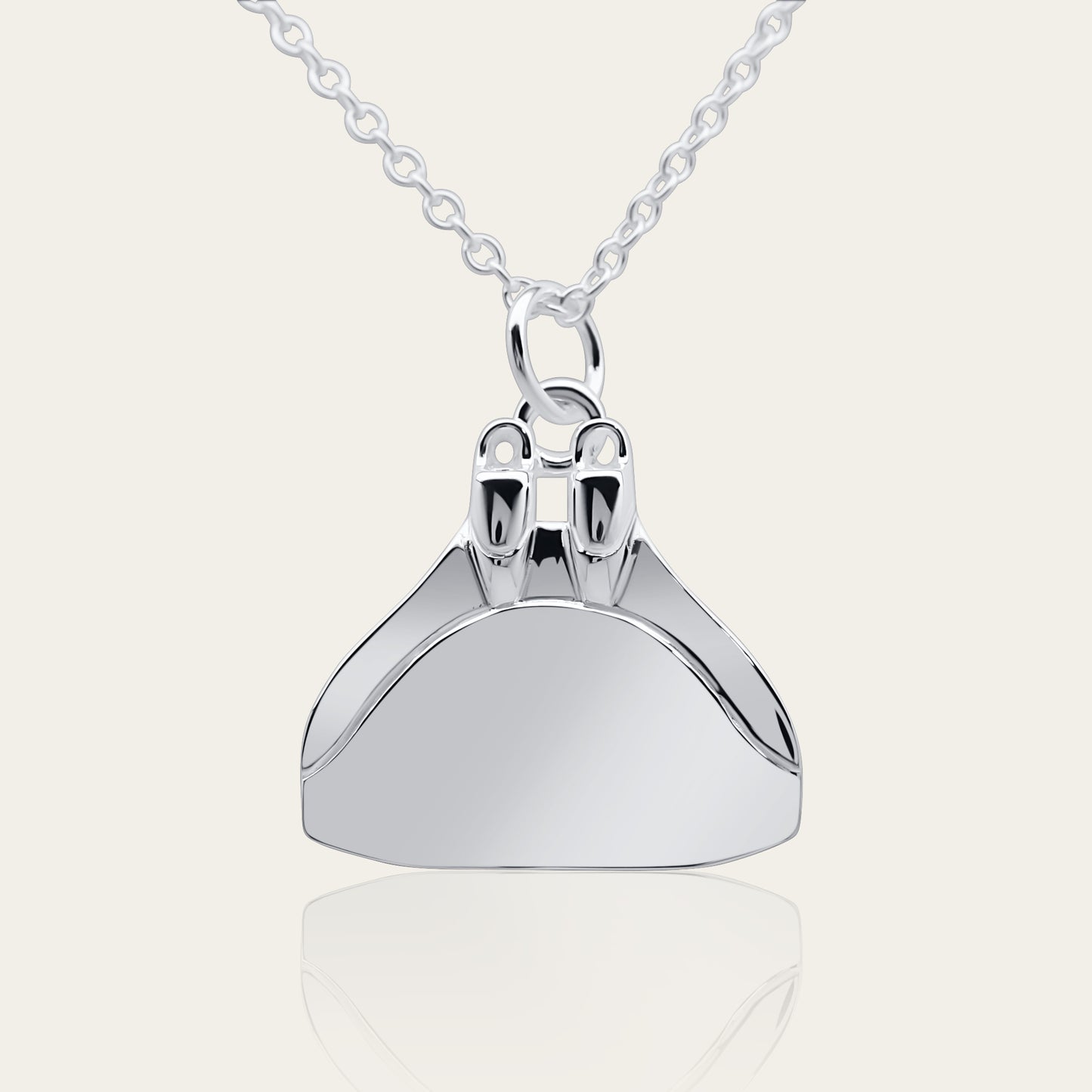 Freediving monofin or monoplame necklace. Made from highly polished, tarnish resistant silver, hung on a silver chain. © Adrian Ashley