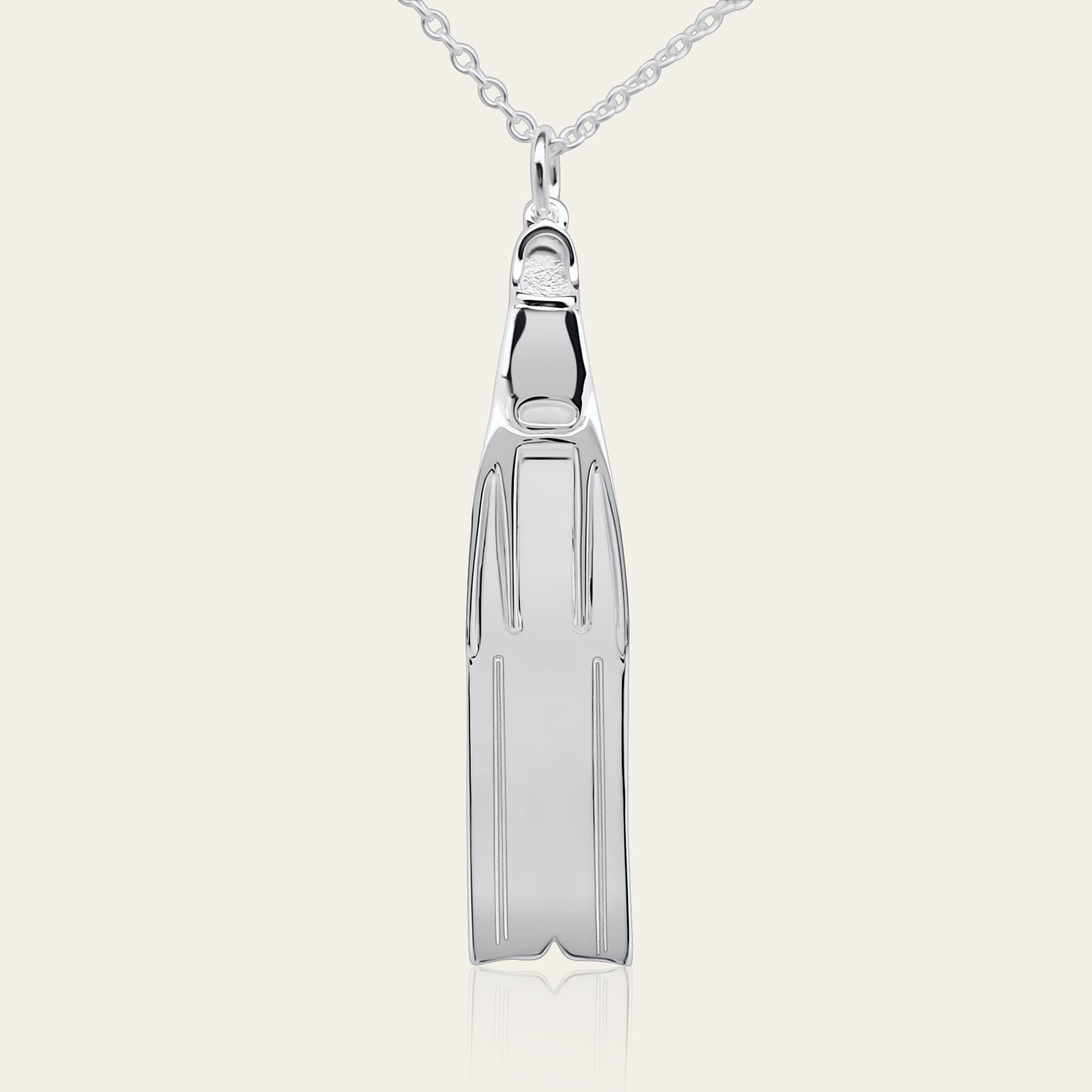 Freediving fin necklace. Made from highly polished, tarnish resistant silver, hung on a solid silver chain. © Adrian Ashley