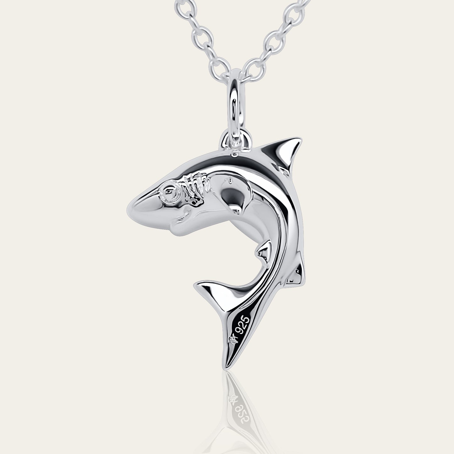 Baby shark charm 3D necklace made from highly polished, tarnish resistant silver, hung on a solid silver chain. © Adrian Ashley