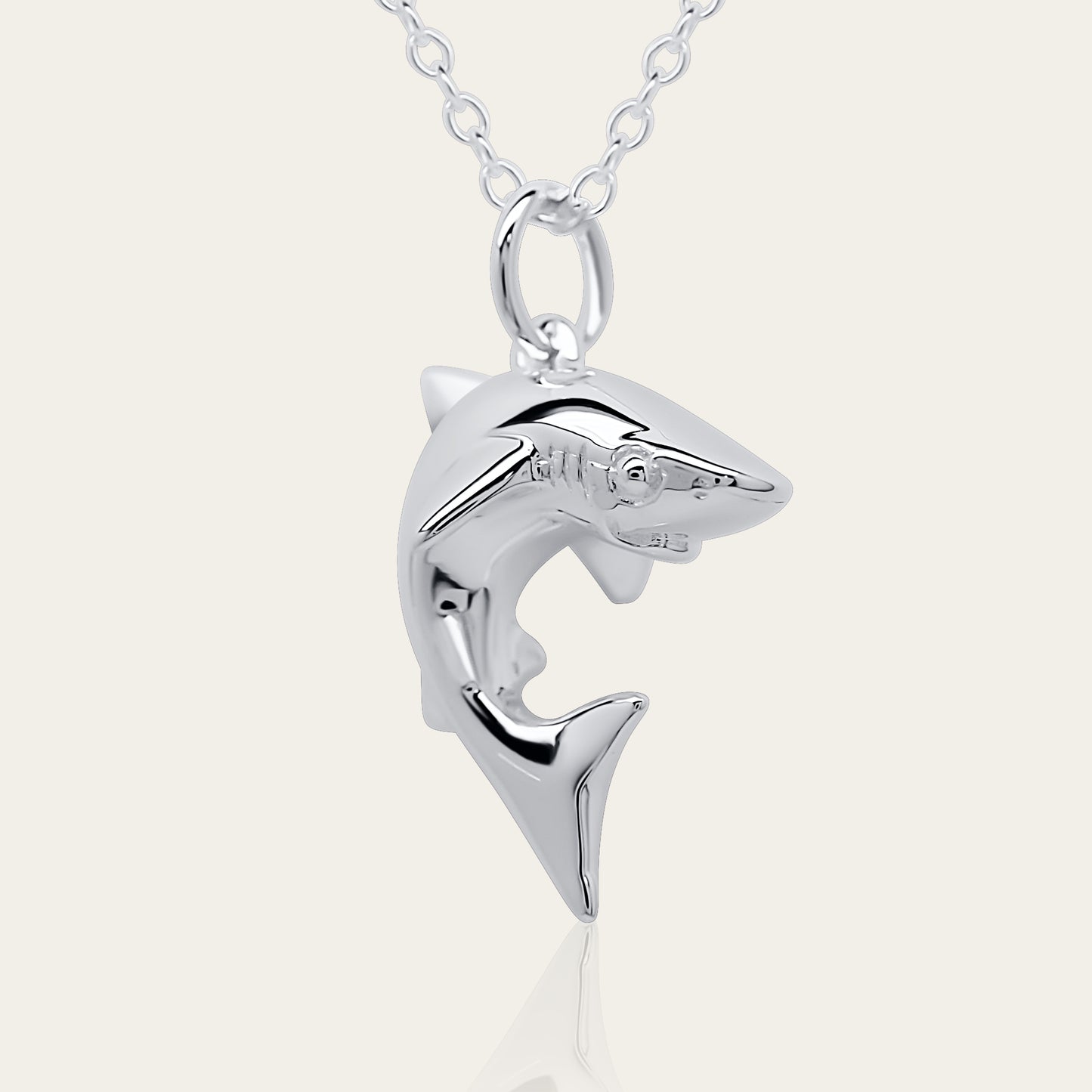 Baby shark charm 3D necklace made from highly polished, tarnish resistant silver, hung on a solid silver chain. © Adrian Ashley