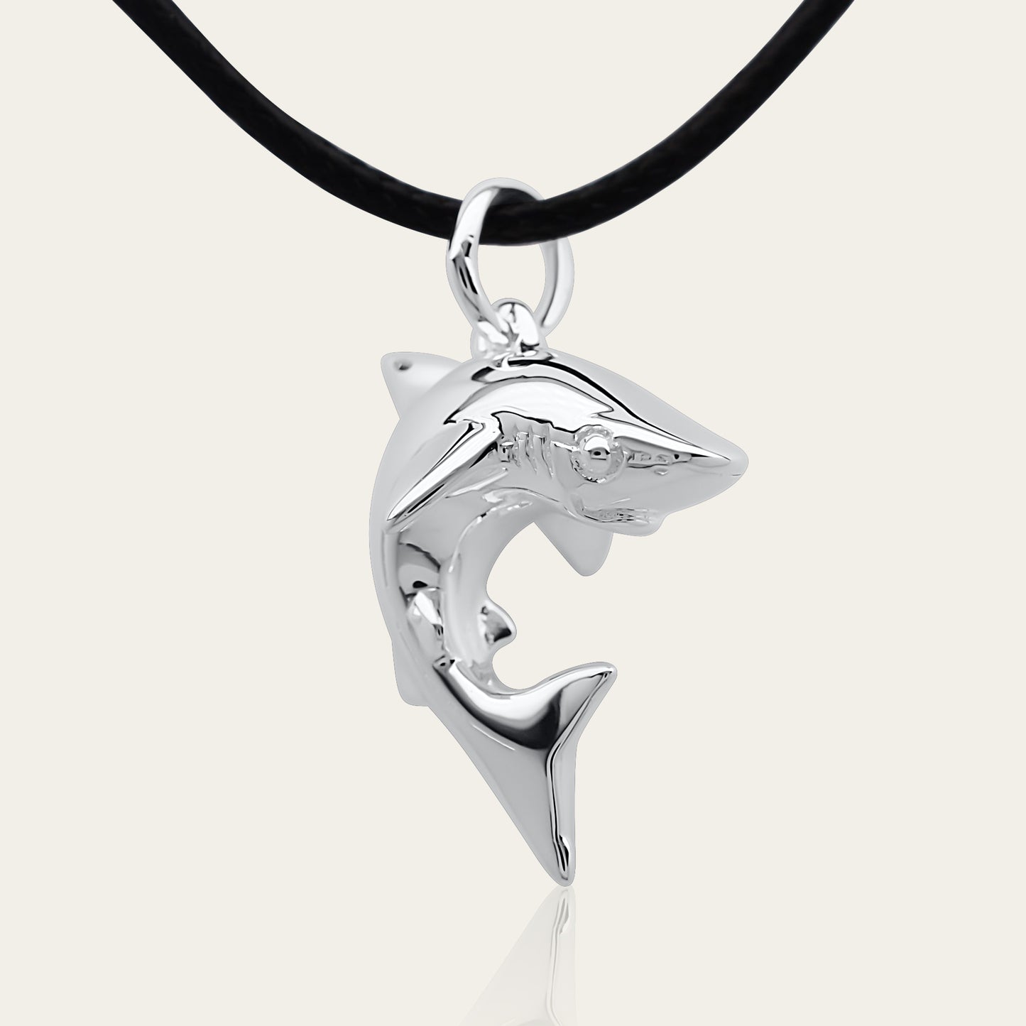 Baby shark charm 3D necklace made from highly polished, tarnish resistant silver, strung on a strong cord. © Adrian Ashley