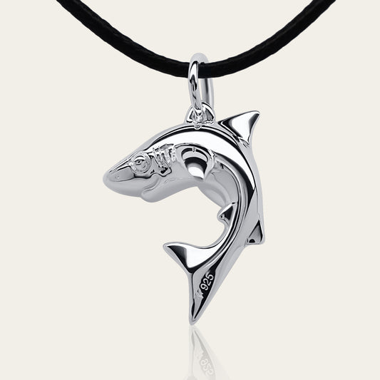 Baby shark charm 3D necklace made from highly polished, tarnish resistant silver, strung on a strong cord. © Adrian Ashley