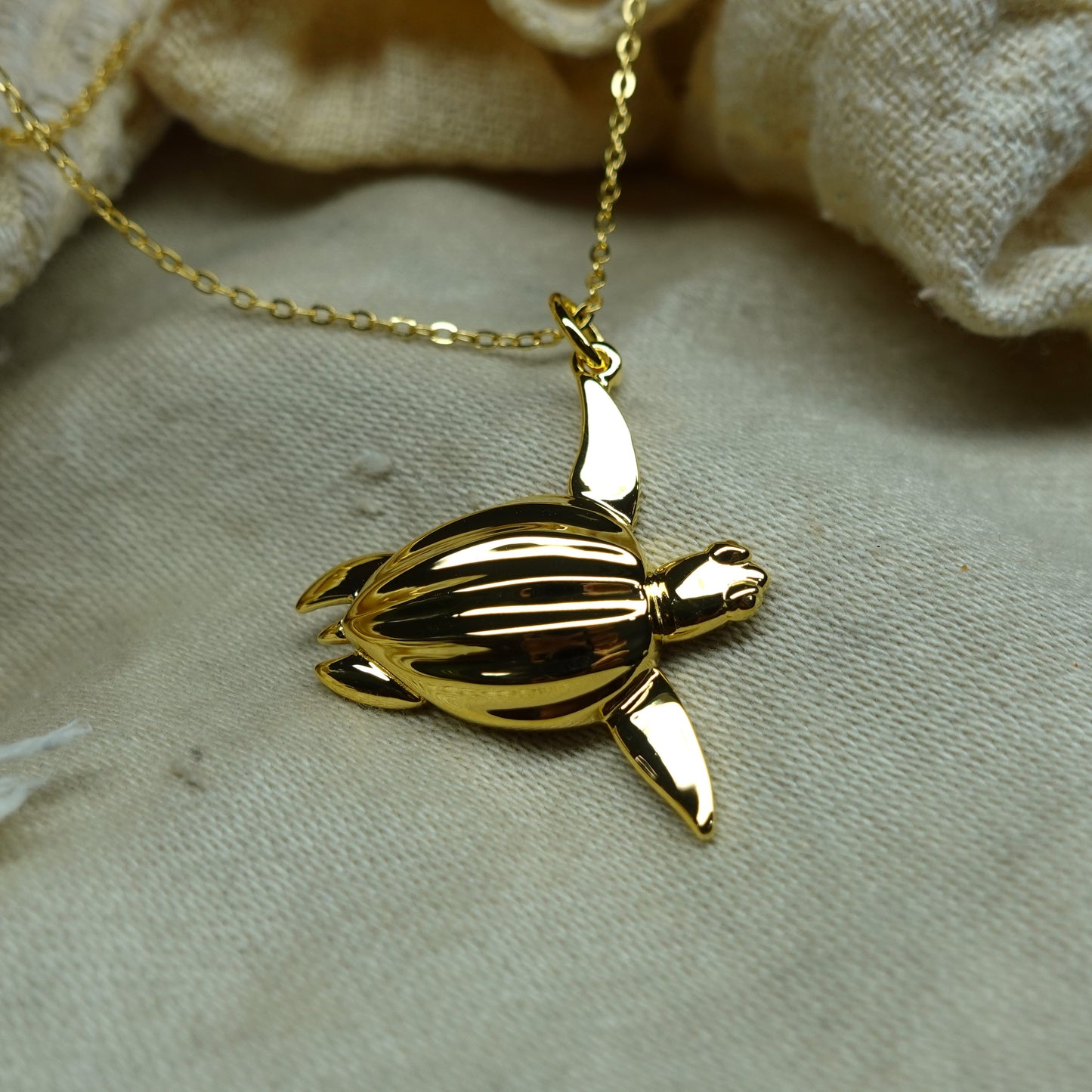 Gold plated silver Sea Turtle pendant and chain. © Adrian Ashley