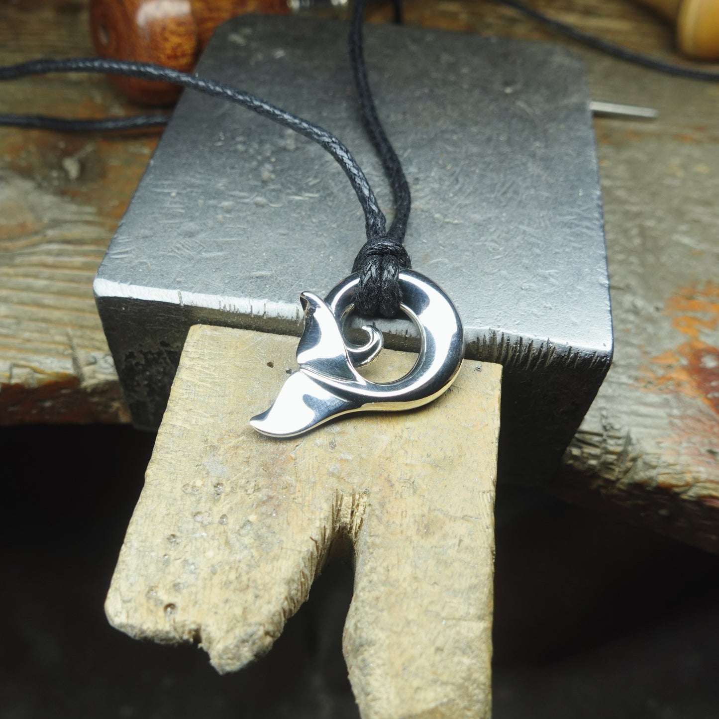 Whale spirit necklace. Made from highly polished, tarnish resistant silver, strung on a strong cord. © Adrian Ashley