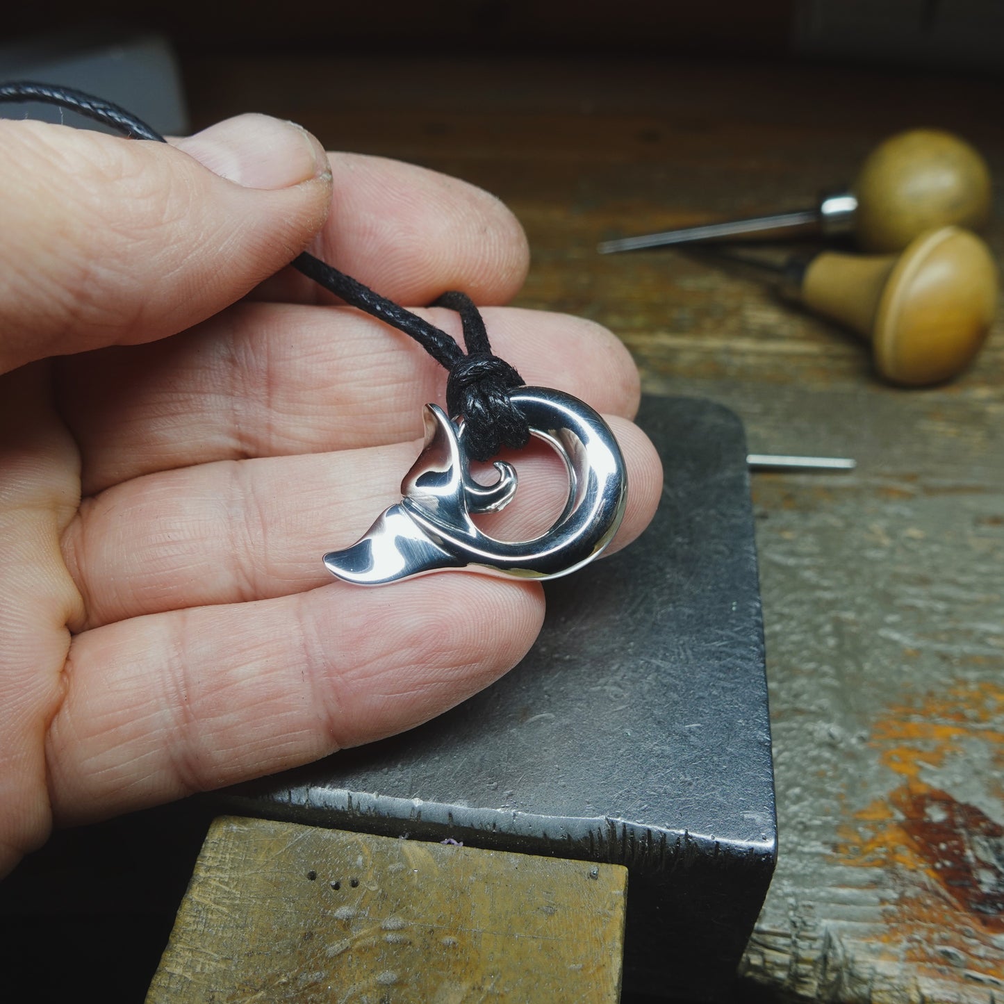 Whale spirit necklace. Made from highly polished, tarnish resistant silver, strung on a strong cord. © Adrian Ashley