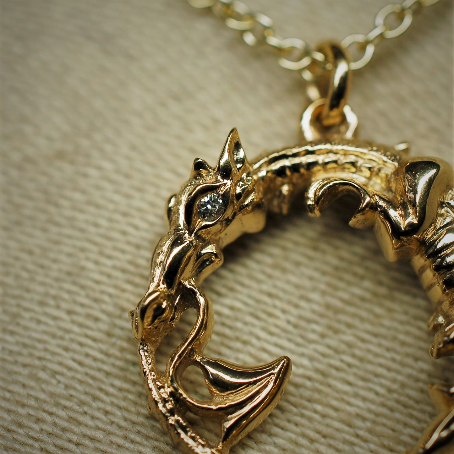 Gold dragon necklace. Diamond eyed ouroboros dragon talisman. Hand made to order. © Adrian Ashley