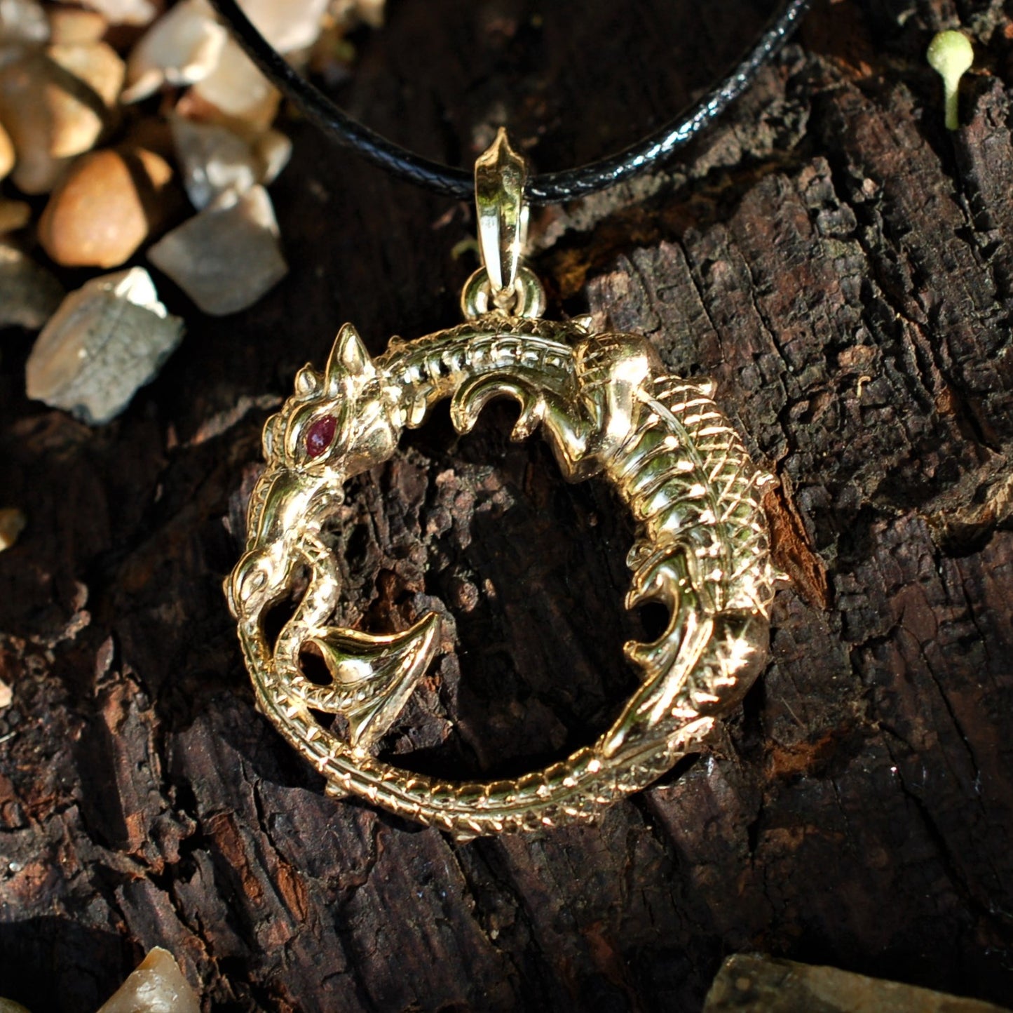 Mid-sized ouroboros dragon pendant with a bail for chains. Gold dragon with a ruby eye. Hand made to order. © Adrian Ashley