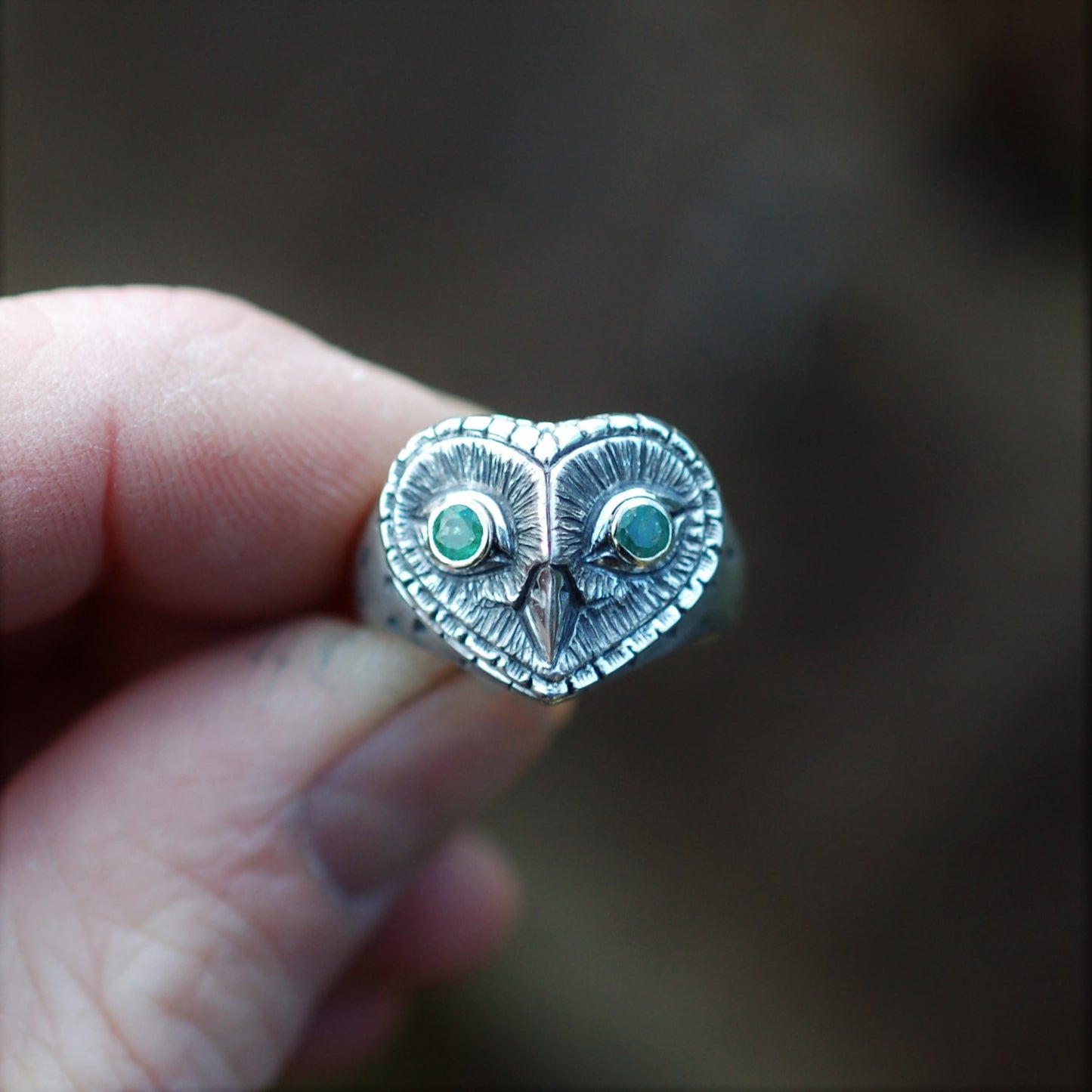 Owl ring, silver gold and emerald ring, sterling silver barn owl with gold and emerald eyes, antique finish. © Adrian Ashley