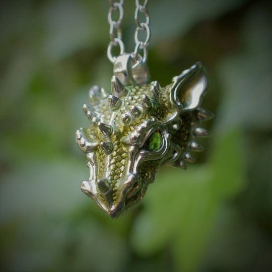 Green dragon necklace. Sterling silver dragon pendant, with natural peridot eyes and a solid silver chain. Made to order. © Adrian Ashley