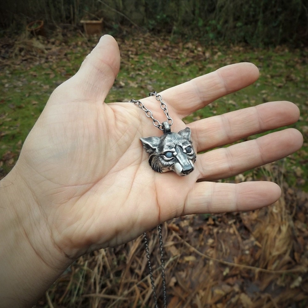 Wolf Necklace. Sterling silver wolf's head pendant with moonstone eyes and a silver chain. Hand made to order. © Adrian Ashley
