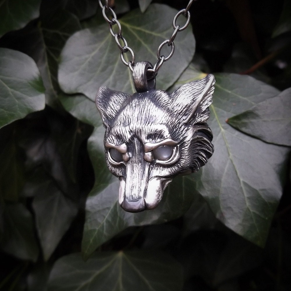 Wolf Necklace. Sterling silver wolf's head pendant with moonstone eyes and a silver chain. Hand made to order. © Adrian Ashley