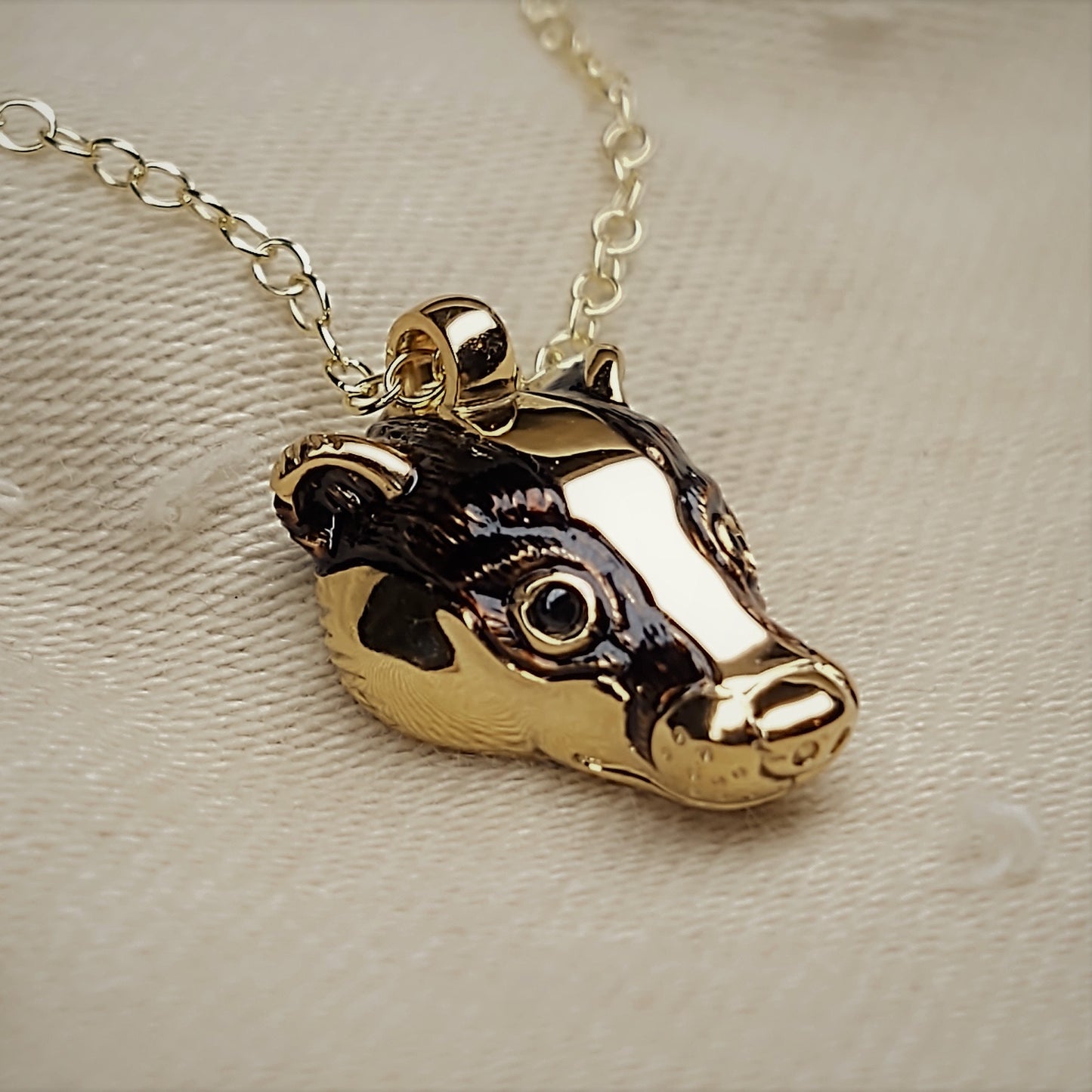 Gold badger Necklace, gold and natural sapphire badger head pendant with a solid gold chain. This piece will be hand made for you in the UK. © Adrian Ashley