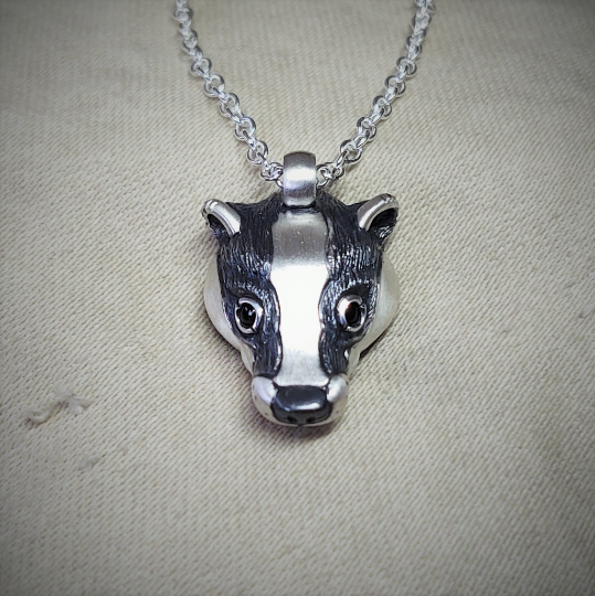 Small silver badger Necklace. Sterling silver pendant with natural sapphire eyes and a solid silver chain. Hand made to order. © Adrian Ashley