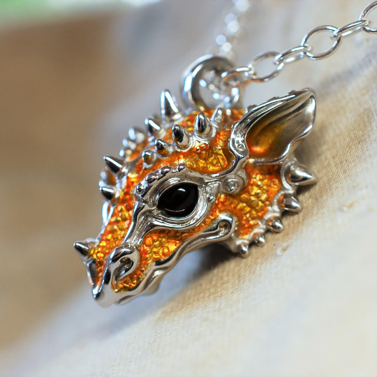 Yellow dragon necklace. Sterling silver dragon pendant, with natural amber eyes and a solid silver chain. Made to order. © Adrian Ashley