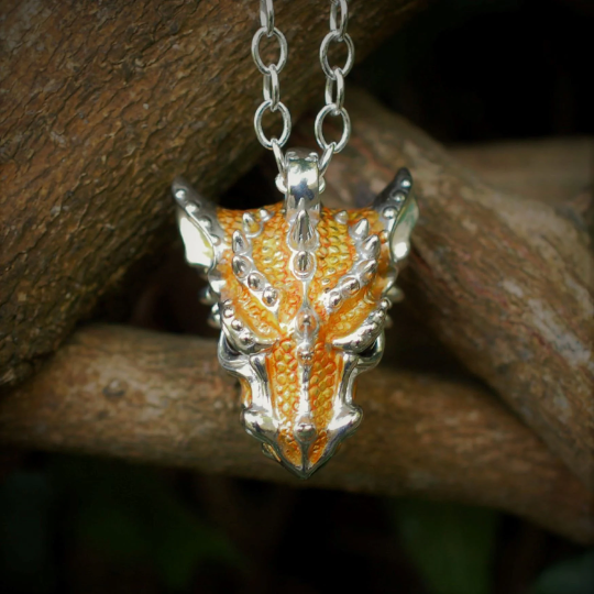 Yellow dragon necklace. Sterling silver dragon pendant, with natural amber eyes and a solid silver chain. Made to order. © Adrian Ashley